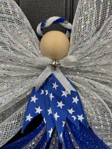 Close up view of Blue, white and silver deco mesh angel with blue ribbon with white stars, wooden head, silver bow and bell with blue and white halo on a black door. 