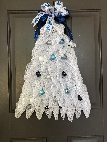 White Deco Mesh Christmas Tree Wreath with Shades of Blue Balls with Blue Bow on Top on a Gray Door