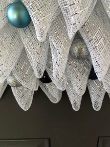 Close Up Detail of White, Triangle Shaped Deco Mesh with Blue and Silver Christmas Balls