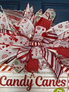 closeup of candy cane peppermint ribbon on candy cane Christmas wreath
