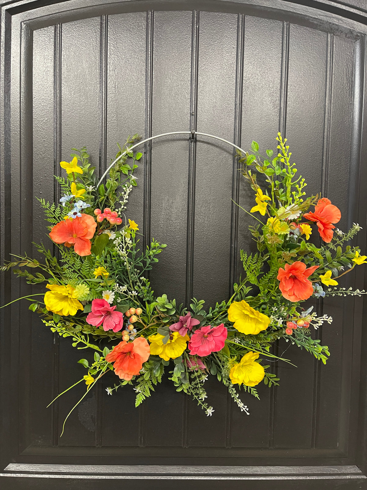 Orange, Pink and Yellow Cosmos Florals with Meadow Greens on a Silver Hoop Wreath on a Black Door