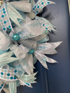 Close Up Detail of Blue and Silver Christmas Balls, Blue and White Snowflake Ribbon with Blue Birch Bark Ribbon, Snow Covered Christmas Tree Ribbons and White and Silver Deco Mesh Curls
