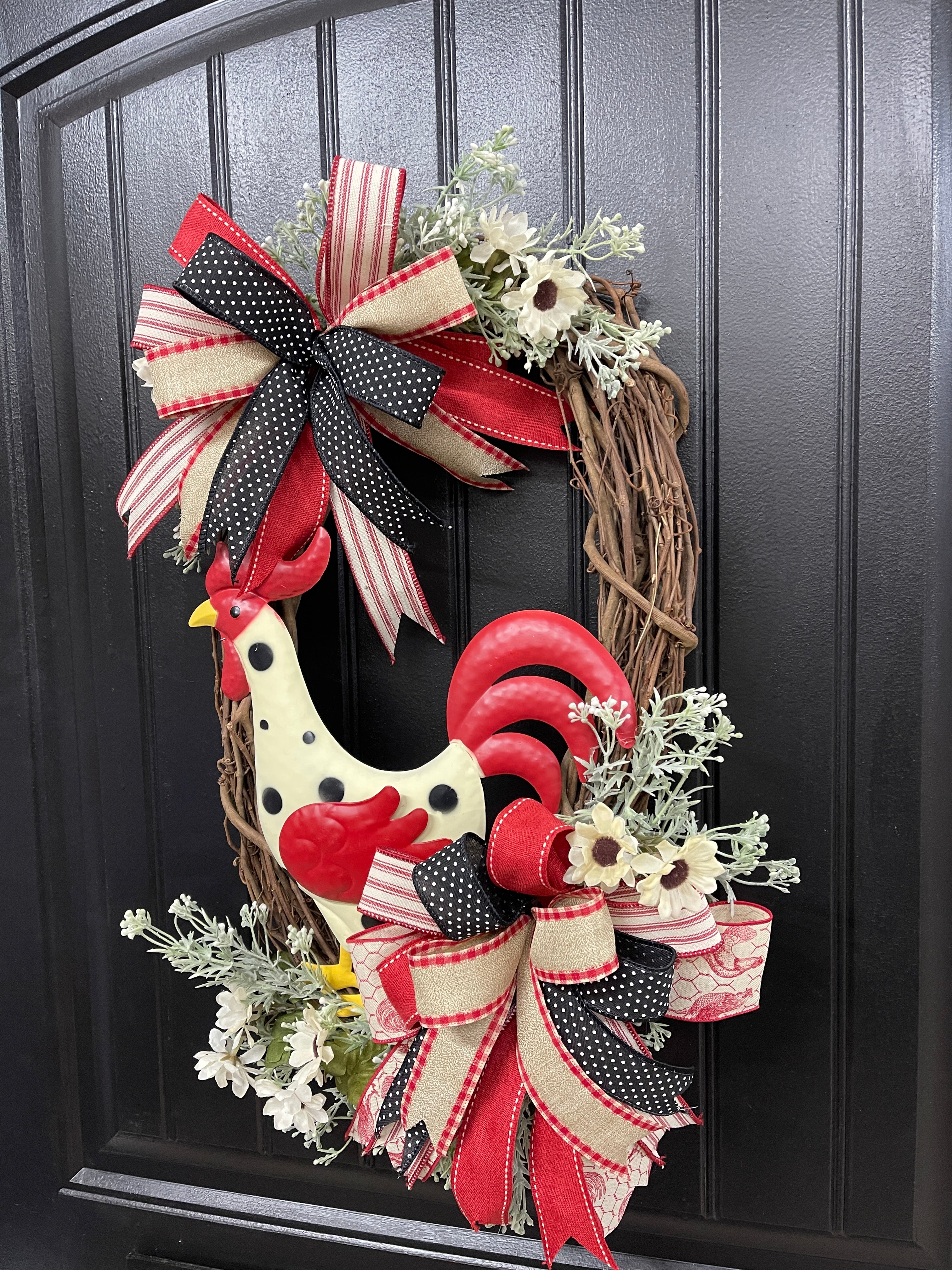 Right Side View of Metal Red, Black and Tan Rooster Floral Grapevine Wreath with 2 bows on Black Door