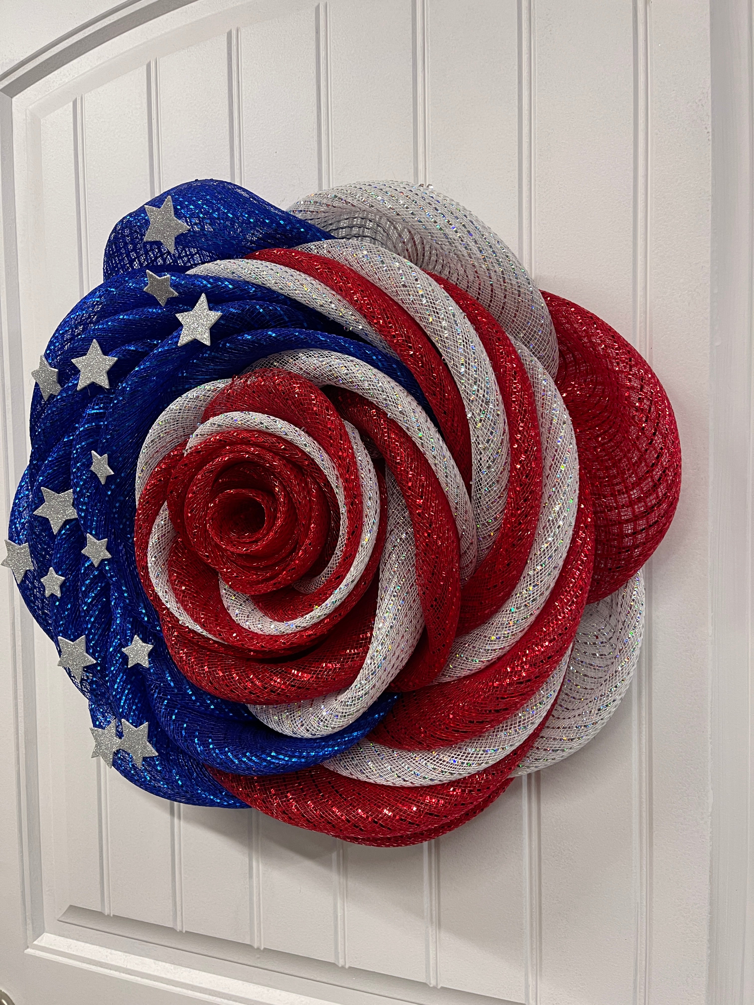 Right Side View of Red, White and Blue Deco Mesh Rose Flower Wreath with Silver Stars on a White Door