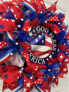 Left Side View of Red, White and Blue Stars and Stripes, God Bless America Deco Mesh Wreath on a White Door