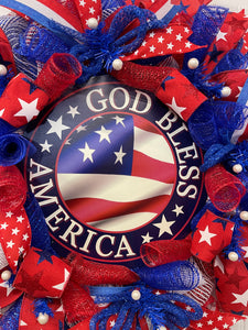 Close Up Detail of Round God Bless America Sign with an American flag in the center