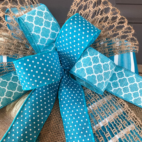 Close up of Bow featuring Blue, White and Tan Ribbons