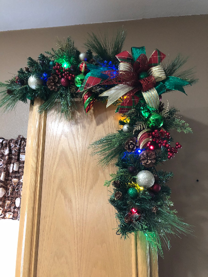 Christmas lighted garland or corner swage in green, red, gold, and blue