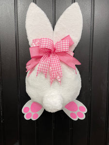 Pink and White Fabric Plush Bunny Butt Wreath with a Pink and White Bow on a Black Door
