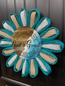 Right Side View of Teal, White and Beige Deco Mesh Daisy Chain Petal Wreath with a Sign that reads, "All the Time God is Good" on a black door.