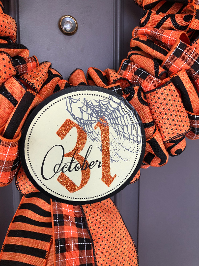 Close Up of Circle October 31st Sign with Cobwebs on Halloween Wreath