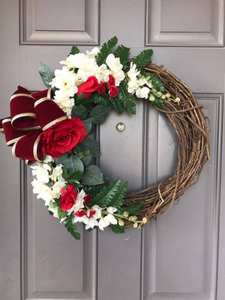 Red Rose and White Delphinium Floral Grapevine and Fern Wreath with Gold and Red Velvet Bow on a Gray Door