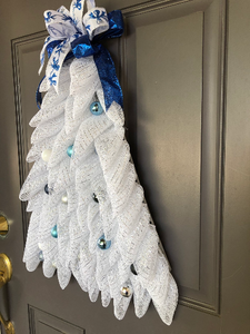 Right Side View of White Deco Mesh Christmas Tree Wreath with Shades of Blue Balls with Blue Bow on Top on a Gray Door