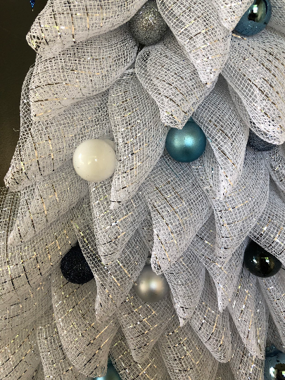 Close Up Detail of White, Triangle Shaped Deco Mesh with Blue, White, Gray and Silver Christmas Balls