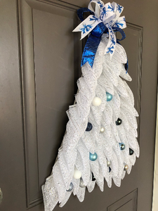 Left Side View of White Deco Mesh Christmas Tree Wreath with Shades of Blue Balls with Blue Bow on Top on a Gray Door
