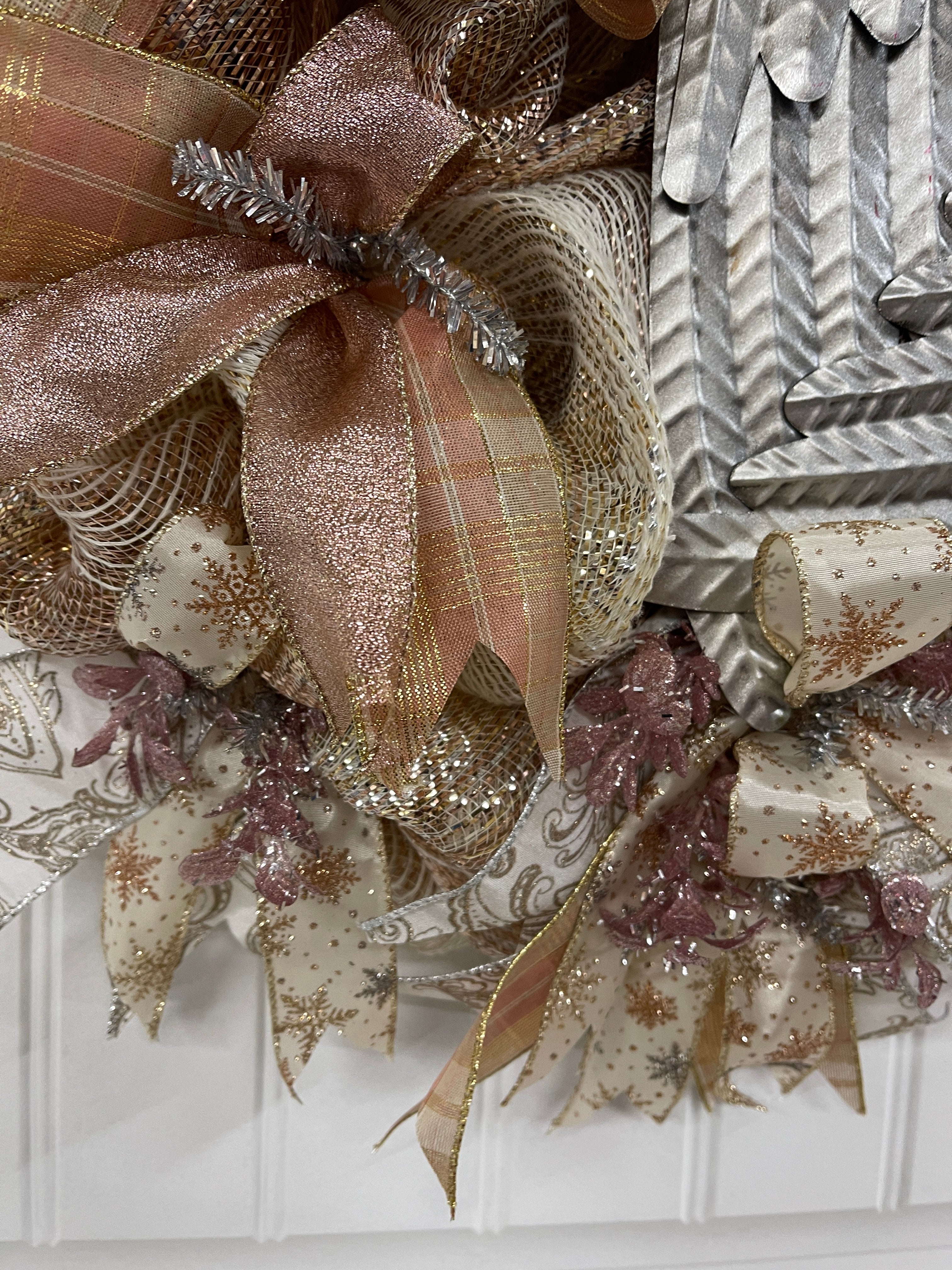 Close of up Ribbons on Rose Gold and Antique Silver Angel Wings Wreath on Front Door