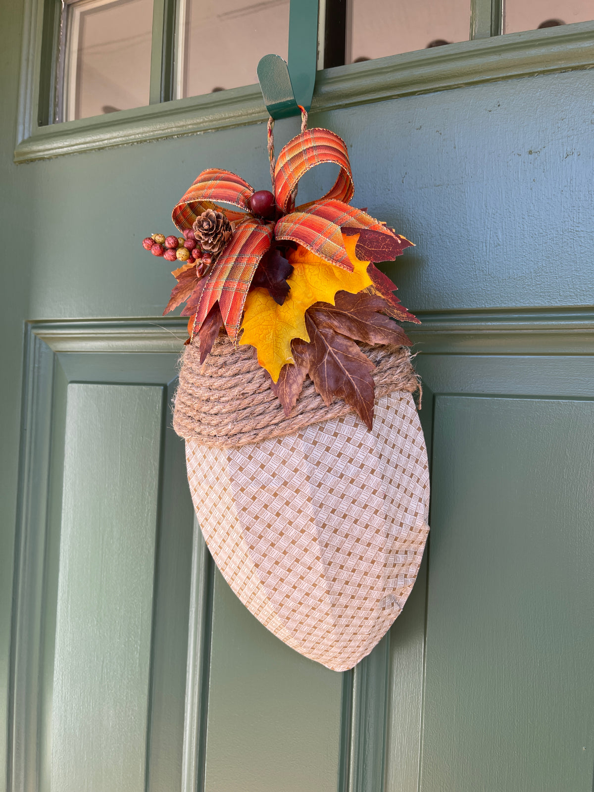 Right Side View of Fall Beige and Cream Basketweave Fabric Covered Acorn Shaped Wreath with Bow and Artificial Fall Leaves, Pinecones and Berries