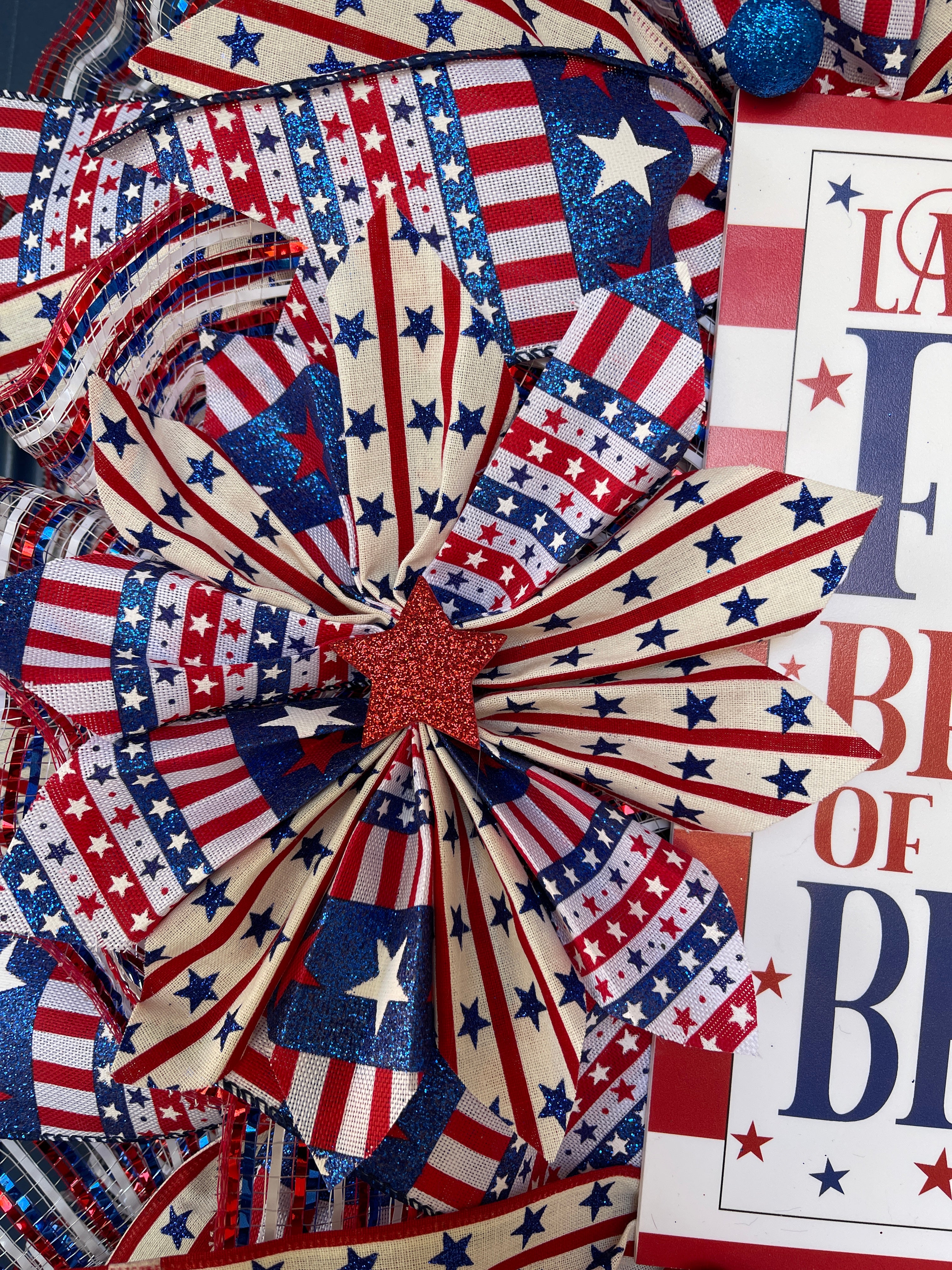 Close Up Detail of Red, White and Blue Ribbon Pinwheel with Red Glitter Star center