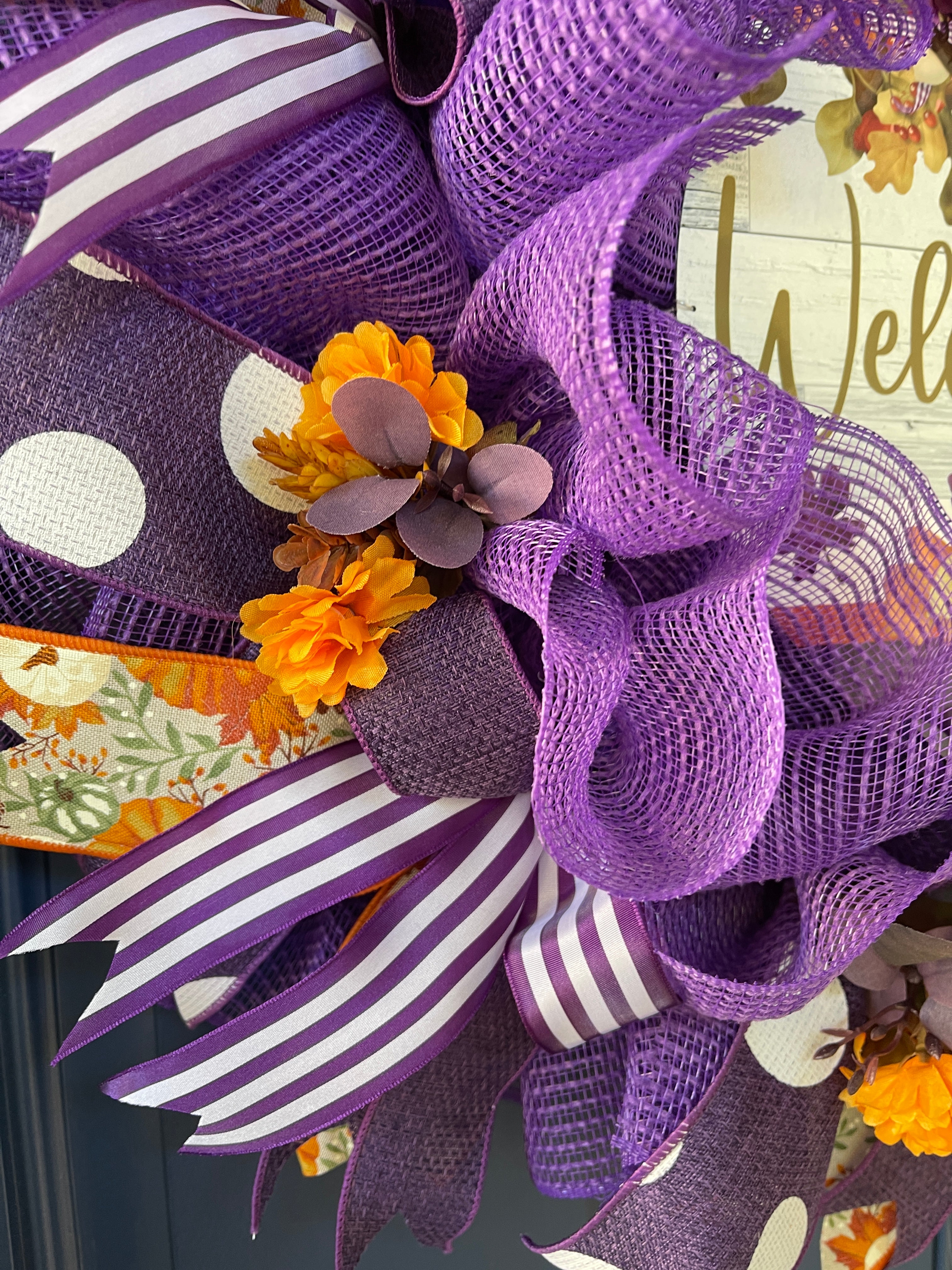 Close Up Details of Orange Mums, Purple Eucalyptus, Purple and White Ribbons with Purple Fabric Deco Mesh and Pumpkin Ribbon