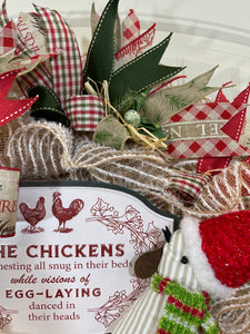 Close up of Red, White and Green Ribbons, Noel Red, White and Beige Ribbon, Small Green Speckled Egg, Raffia and Pine Branches on Christmas Chicken Wreath