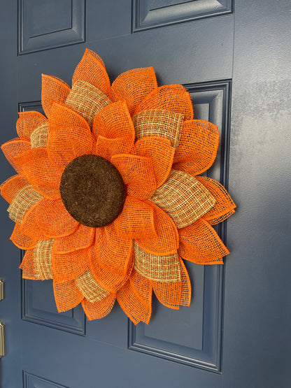 Right Side View of Poly Burlap Mesh Sunflower Wreath Featuring Orange and Patterned Colors of Yellow, Brown and Orange with a Brown Center on a Blue Door