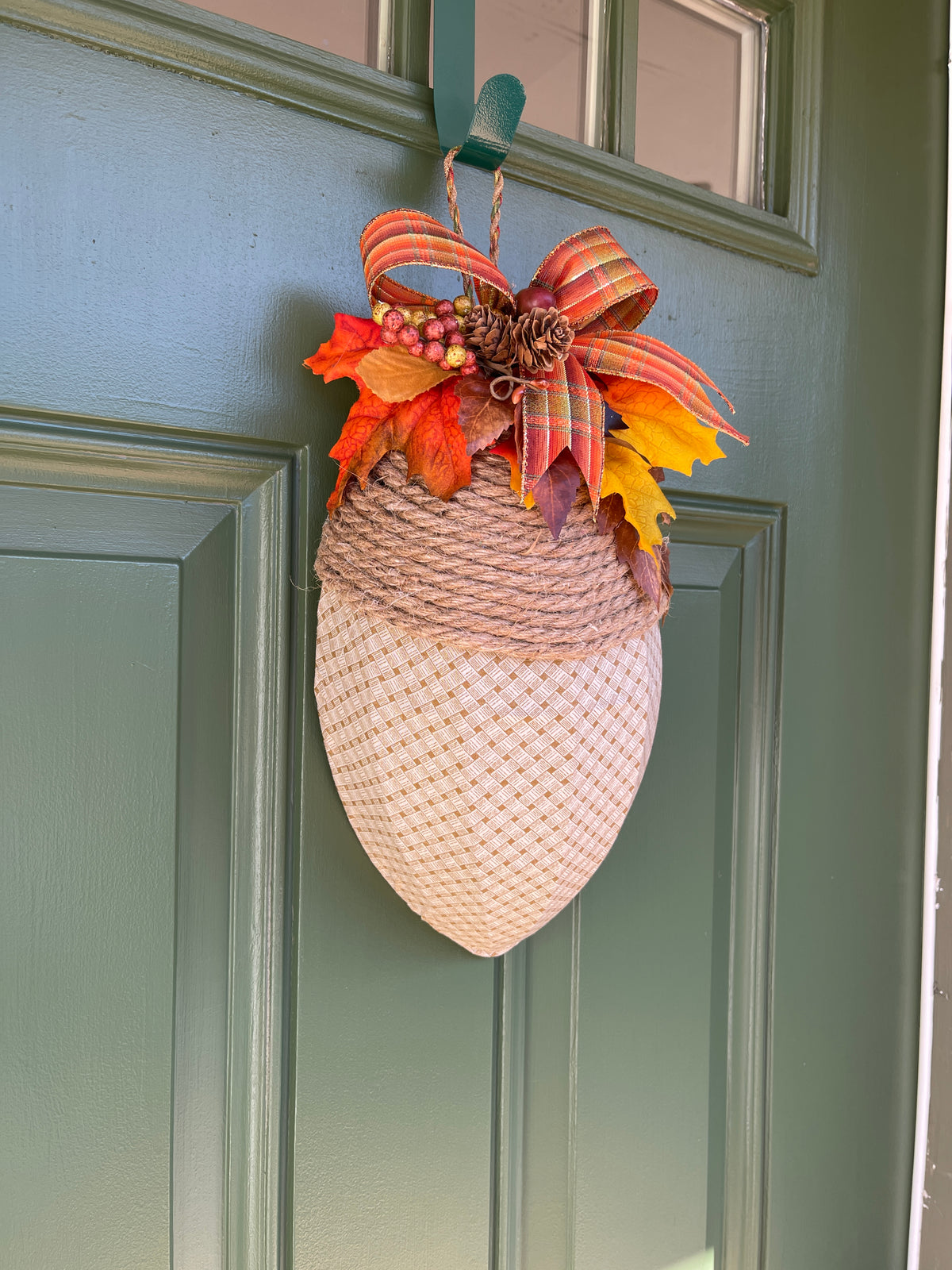 Left Side View of Fall Beige and Cream Basketweave Fabric Covered Acorn Shaped Wreath with Bow and Artificial Fall Leaves, Pinecones and Berries