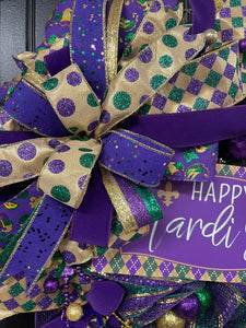 Close Up Detail of Bow with Gold Ribbon with Purple and Green Dots, Solid Purple Ribbon with Glitter, Purple, Gold and Green Striped Ribbon and Purple Velvet Ribbon