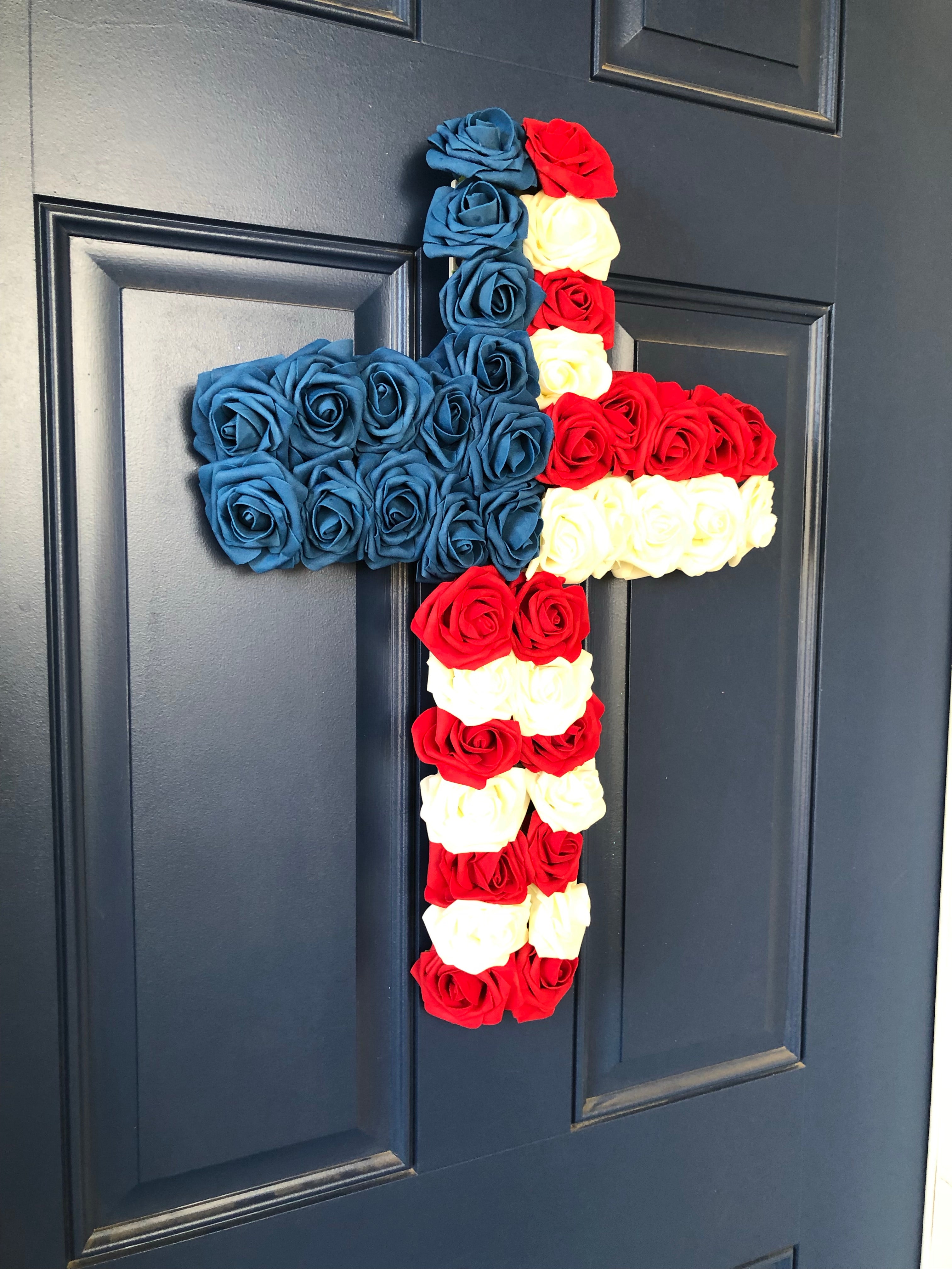 Left Side View of Red, White and Blue Roses in the shape of a cross on a blue door