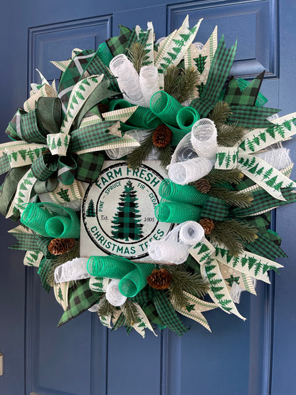 Right Side View of White, Green and Black Deco Mesh Farm Fresh Christmas Wreath on a blue door. 