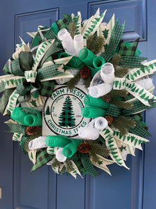 Right Side View of White, Green and Black Deco Mesh Farm Fresh Christmas Wreath on a blue door. 