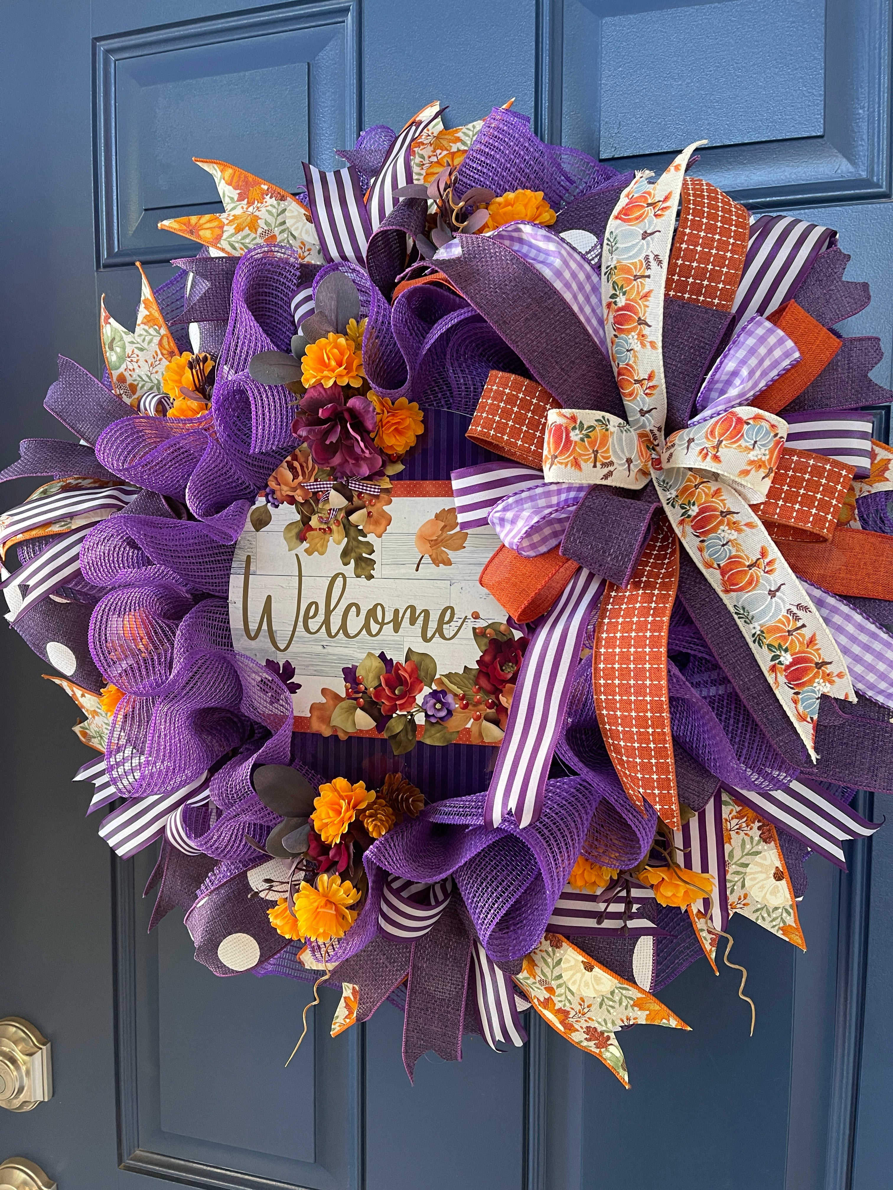 Right Side View of Purple and Orange Deco Mesh and Fall Floral Welcome Wreath on a Blue Door
