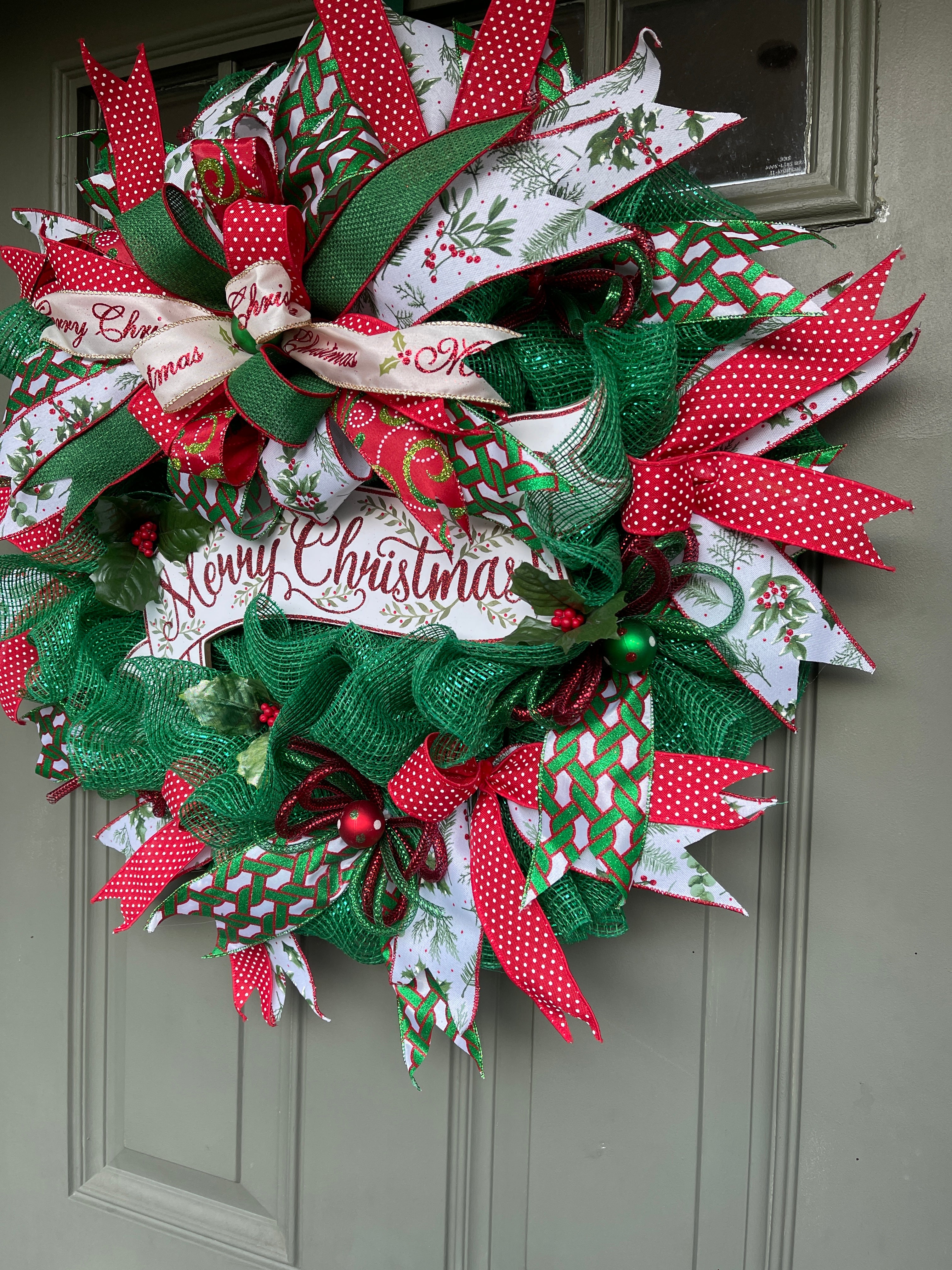 Right Side View of Red, White and Green Merry Christmas Deco Mesh Wreath on a Green Door