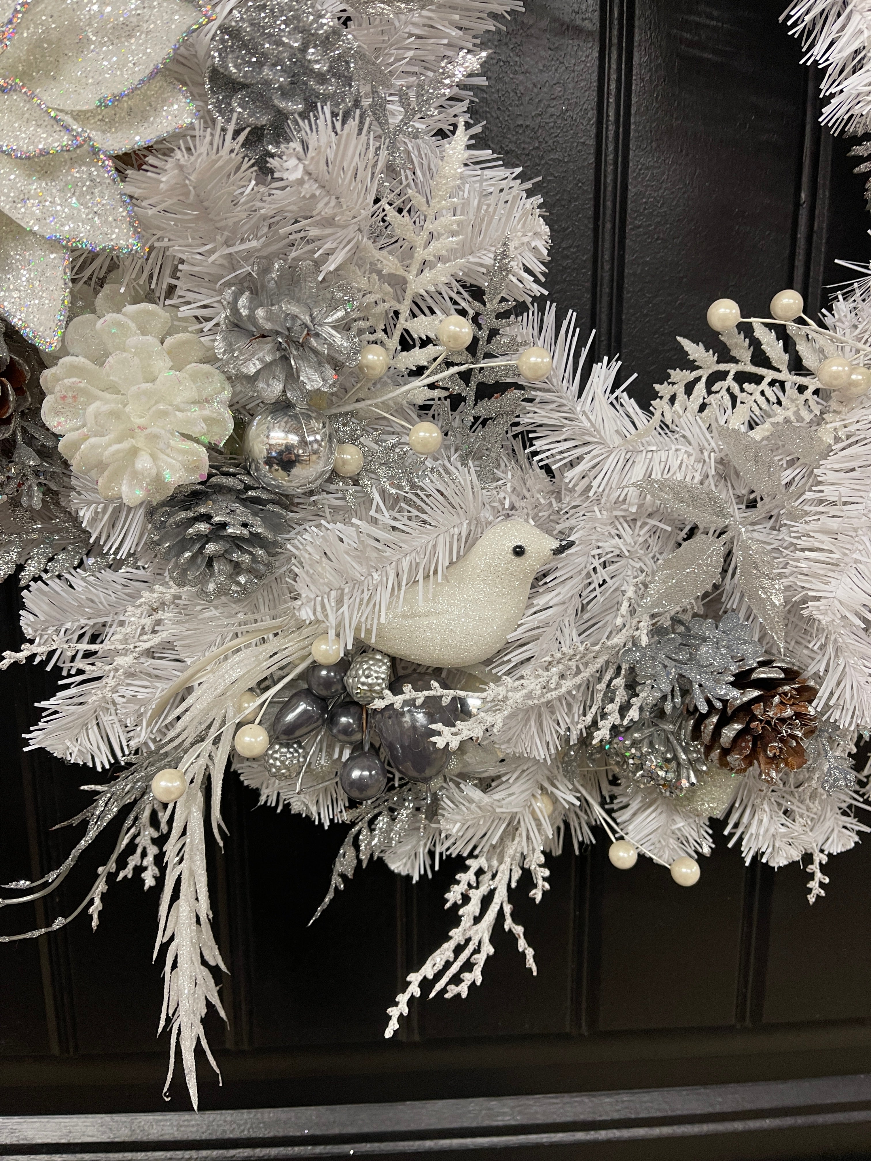 Close Up Detail of White Dove with Gray and White Berries on a White Evergreen with Frosted Pine Cones and White, Silver and Gray Christmas Balls