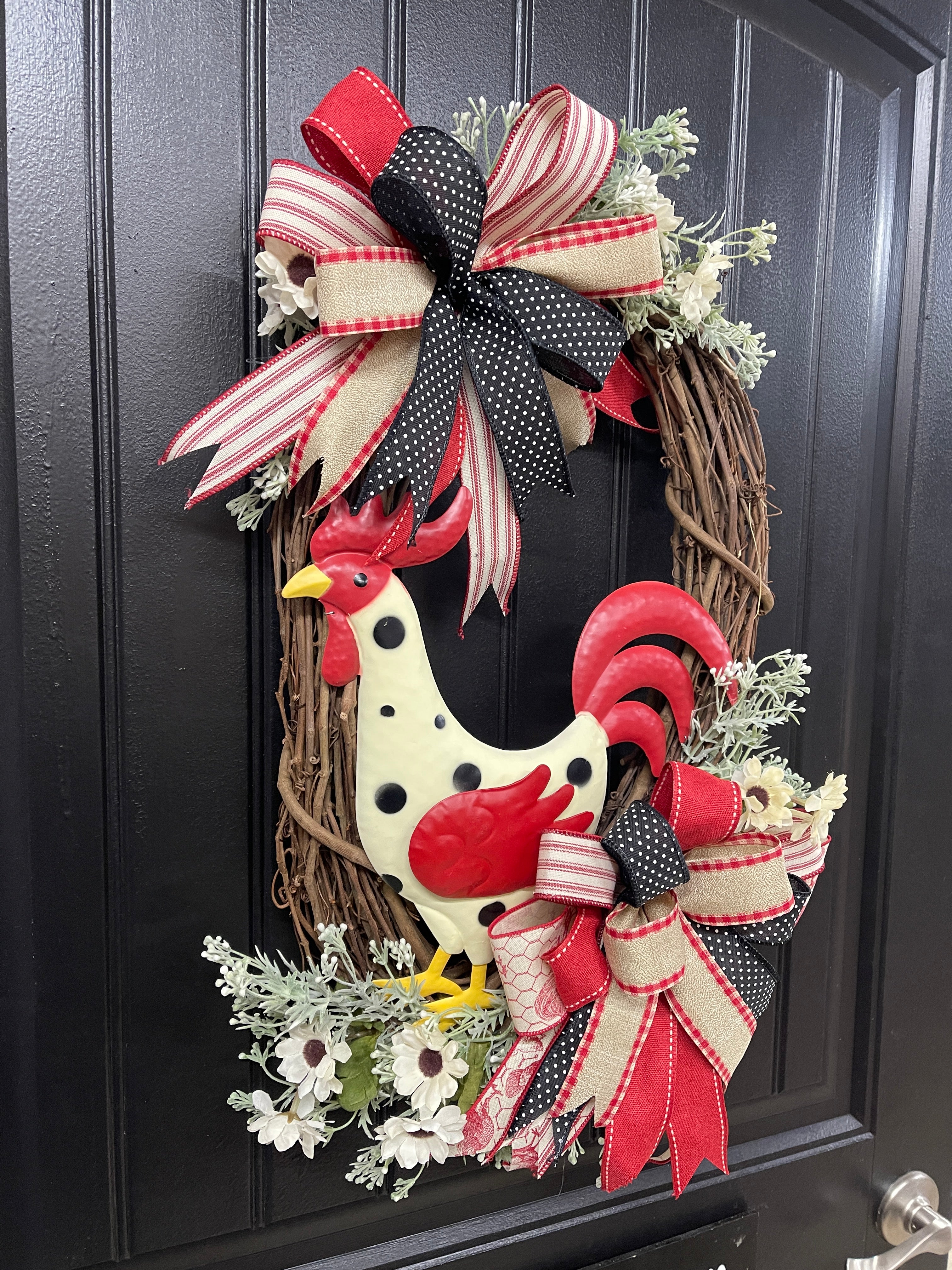Left Side View of Metal Red, Black and Tan Rooster Floral Grapevine Wreath with 2 bows on Black Door