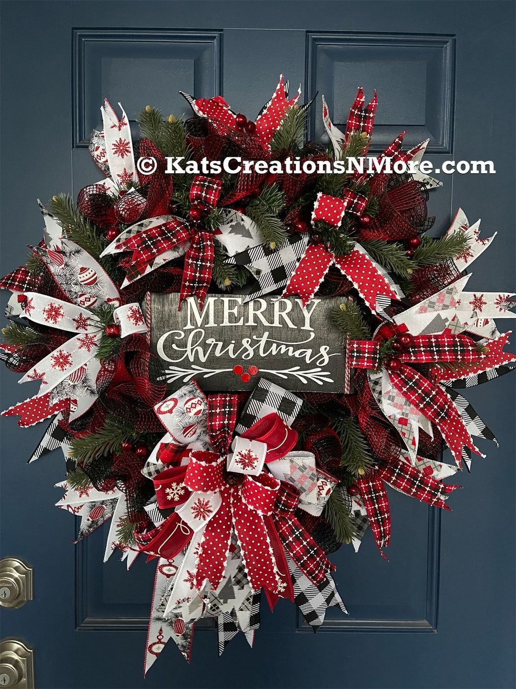 Red, White and Black Evergreen Merry Christmas Wreath with a Bow on a Blue Door