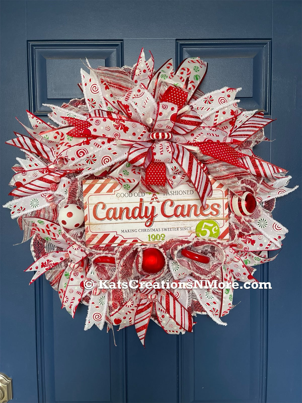 candy cane Christmas wreath with red, white, and accents of green