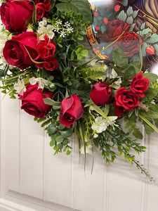 Red Roses with Green Ferns and White Babies Breath Kentucky Derby Run for the Race Wreath with round simulated stained glass sign on a White Door