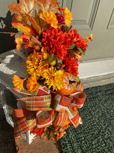 Fall Leaves of Brown, Yellow and Orange, with Orange and Yellow Mums, Pumpkins , Cinnamon Sticks, Red Berries and Pine Cones on a White Lantern on the Porch
