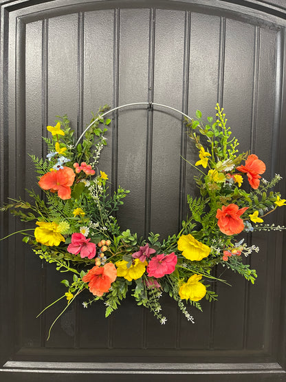 Orange, Pink and Yellow Cosmos Florals with Meadow Greens on a Silver Hoop Wreath on a Black Door