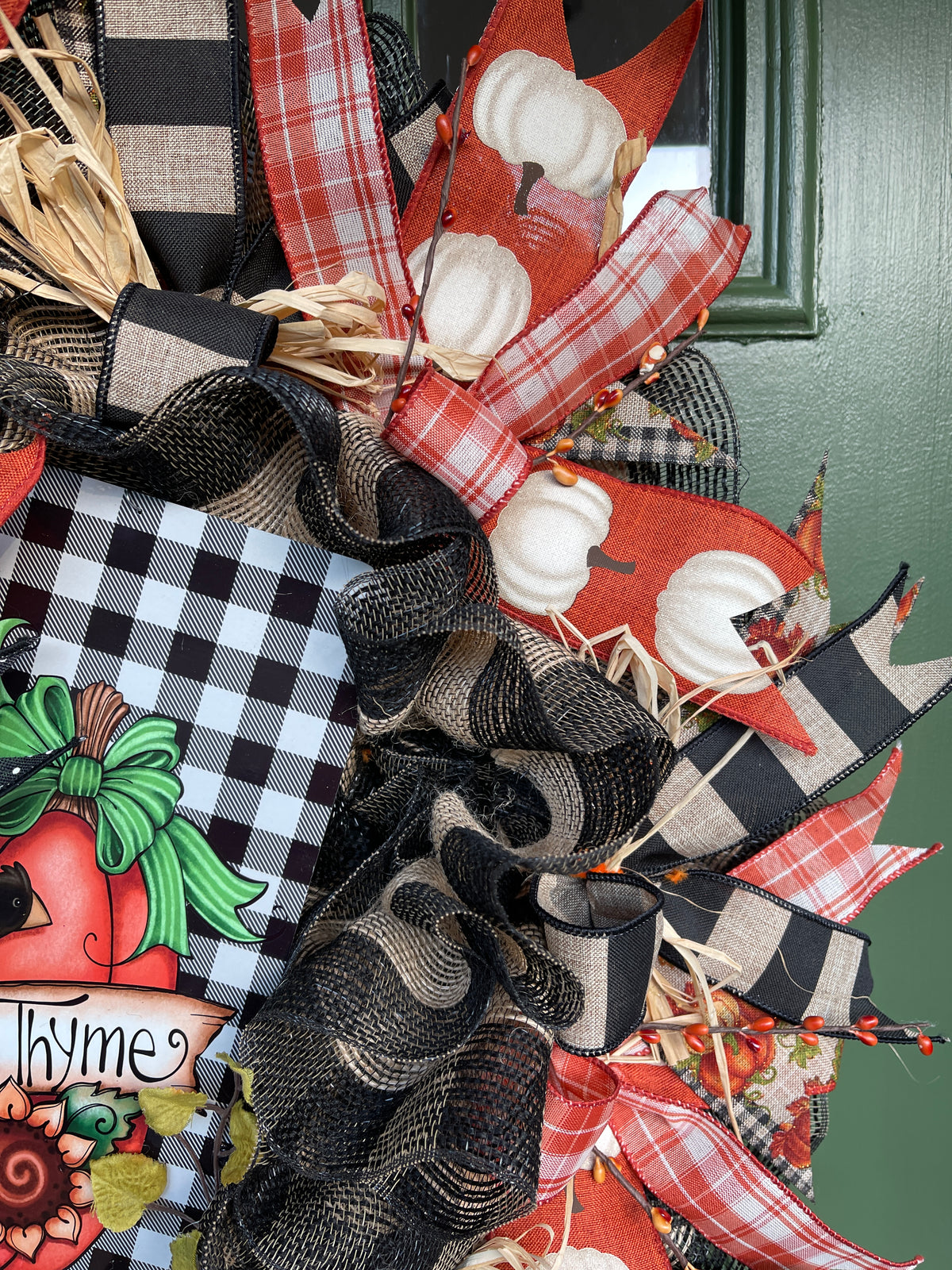 Close Up of Fall Ribbon with White Pumpkins on Orange Ribbon along with a Orange and White Plaid Ribbon, Orange Pip Berries and Natural Raffia on a Fall Wreath