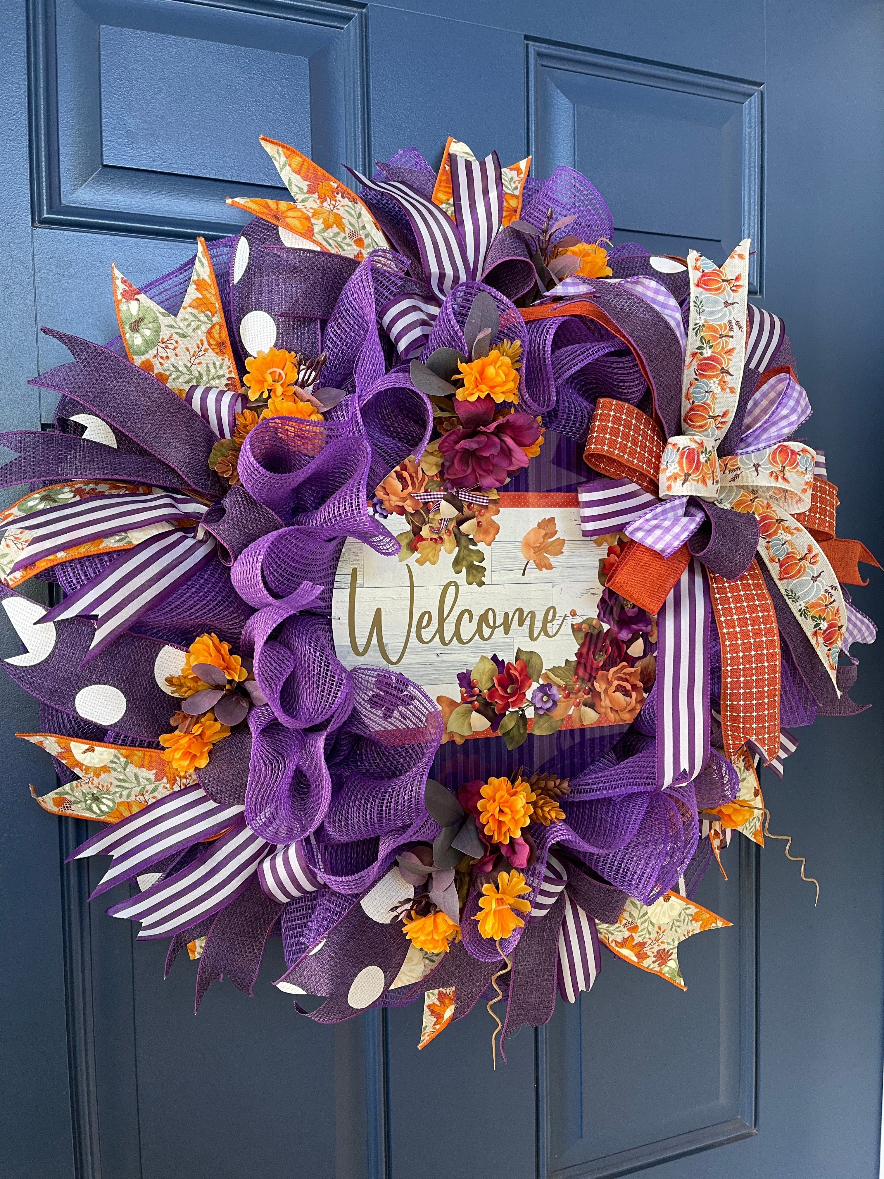 Left Side View of Purple and Orange Deco Mesh and Fall Floral Welcome Wreath on a Blue Door