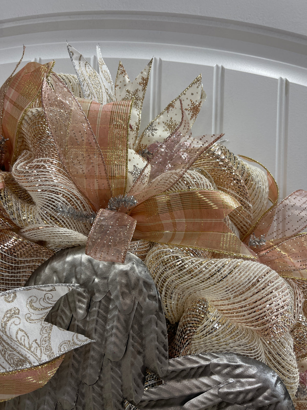 Close of Ribbon on Rose Gold and Antique Silver Angel Wings Wreath on Front Door