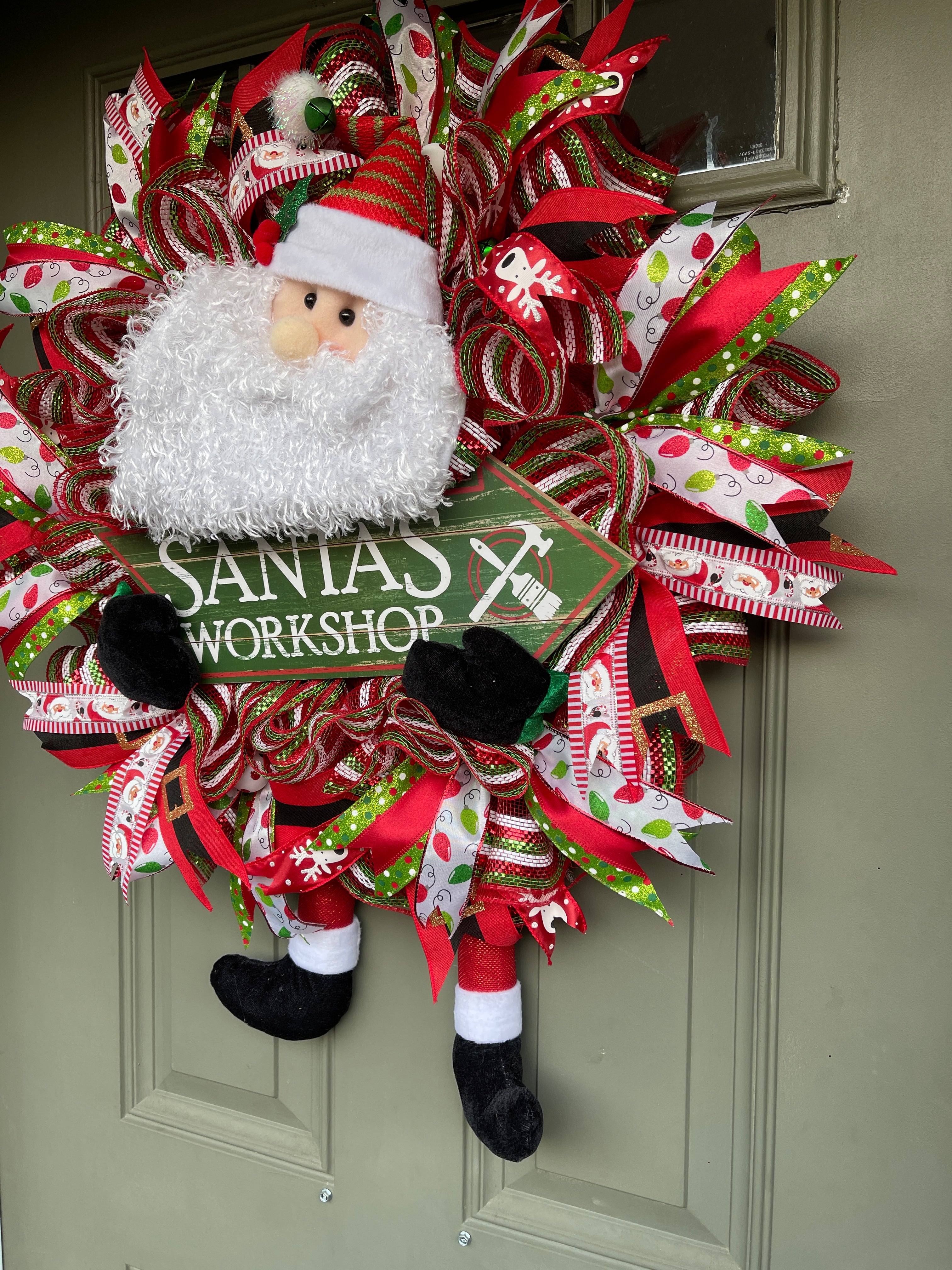 Right Side View of Santa Claus Plush Workshop Red, White and Green Workshop Wreath on a Green Front Door