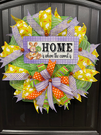 Home is Where the Carrot Is Easter Bunny Wreath with Yellow, Purple, Green, Orange and White Ribbons and Bow on a Black Door