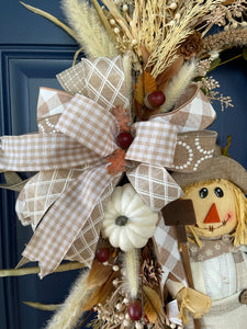 Close Up view of Bow with Beige and White Ribbons, White and Tan Florals and Berries with White Pumpkins on Grapevine Wreath