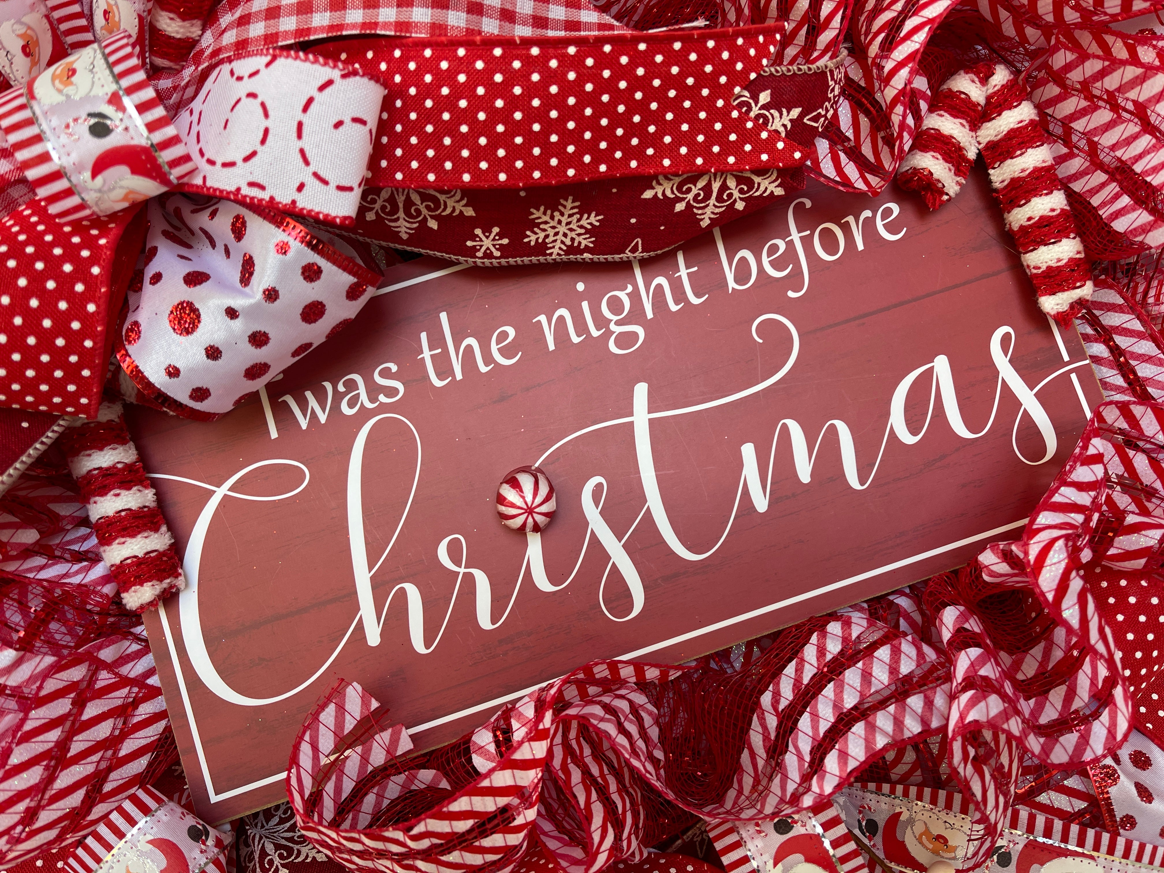 Close Up of Twas the Night Before Christmas Sign with Peppermint on Christmas Wreath