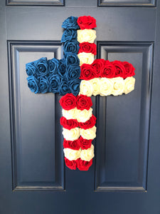 Red, White and Blue Roses in the shape of a cross on a blue door