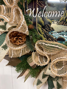 Close Up Details of Welcome Sign, Pine Cones, Jute Snow Drift Tan Mesh and Sprigs on Pine Branches