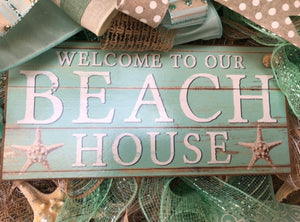 closeup of the sign on the beach house welcome wreath that says Welcome to our Beach House