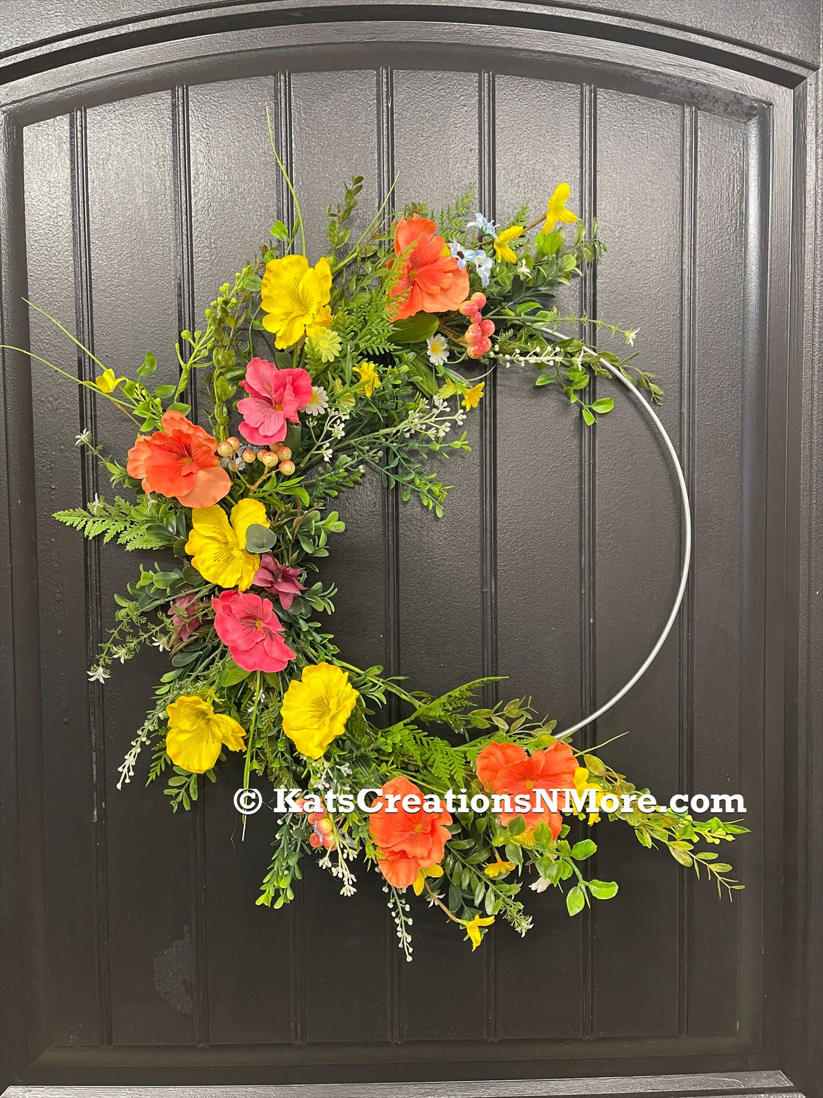 Orange, Pink and Yellow Cosmos Florals with Meadow Greens on a Silver Hoop Wreath on a Black Door